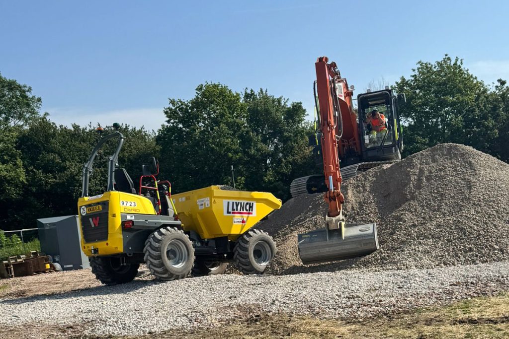 A dumper and excavator moving stone on the Charlotte's Kids Village site during Phase Two works