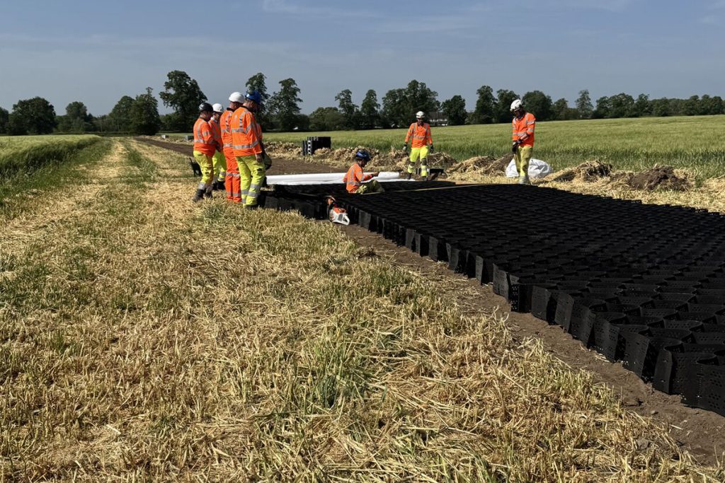 Crown Highways operatives laying cellular ground protection along the route of the new access road